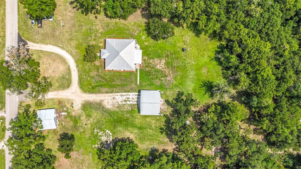 An aerial view shows a house and two outbuildings on a large, grassy, wooded lot — 273 GRIFFIN ROAD, WAUCHULA, FL
