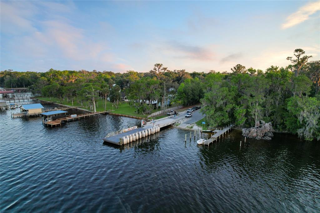 An aerial view shows a boat ramp and wooden docks extending into a lake — 356 DRAYTON ISLAND ROAD, GEORGETOWN, FL