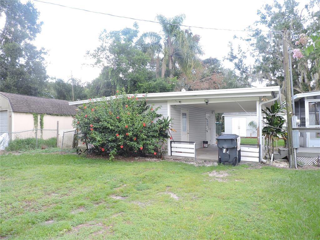 A single-story house with a carport, a large hibiscus bush, and a detached shed — 2530 SNAPPING TURTLE DRIVE, LAKE WALES, FL