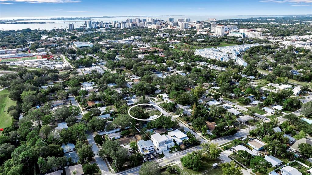 An aerial view shows a residential neighborhood with a vacant lot circled in white — 2350 BAY ST, SARASOTA, FL
