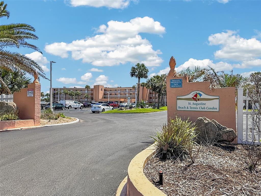 The entrance to the St. Augustine Beach & Tennis Club Condos features a paved driveway — 4 OCEAN TRACE ROAD UNIT 104, ST AUGUSTINE, FL