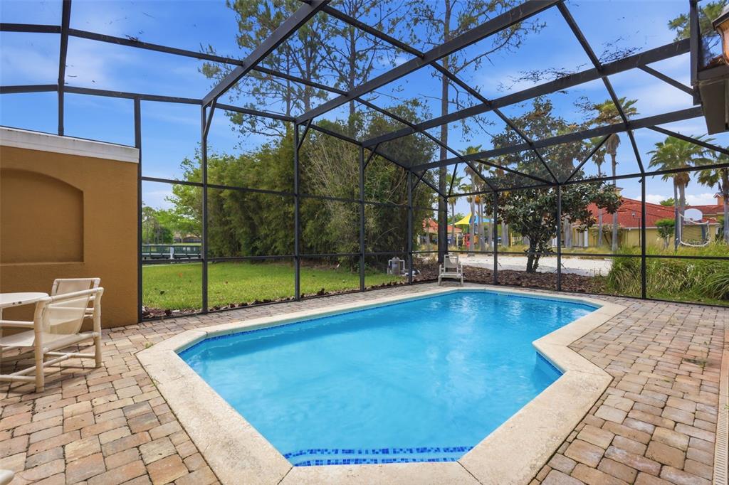 A two-story yellow stucco townhouse with white shutters and a tiled roof — 4722 ORMOND BEACH WAY, KISSIMMEE, FL