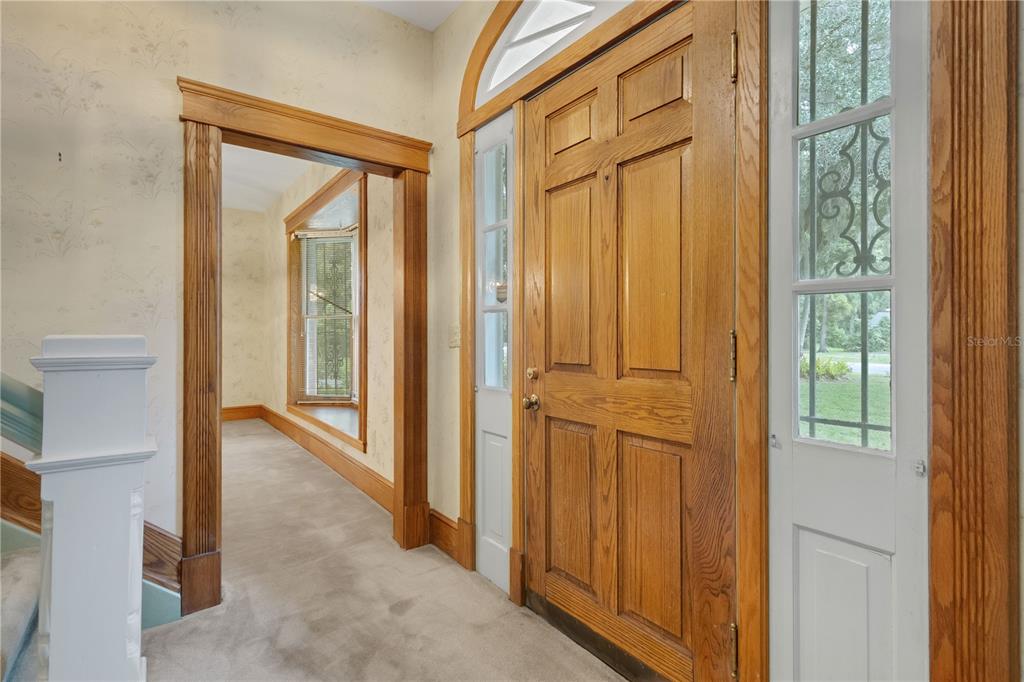 A two-story brick and siding house features a large front lawn and mature oak trees — 820 S OAK AVENUE, BARTOW, FL