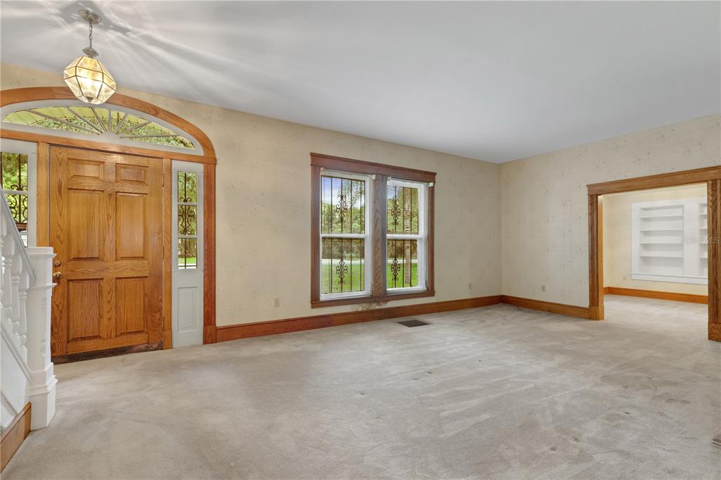 A two-story house with a brick lower level and white siding, surrounded by trees — 820 S OAK AVENUE, BARTOW, FL