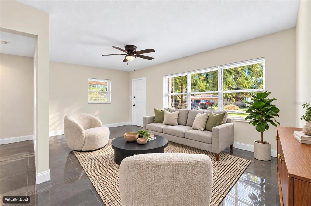 A single-story house with light green siding, a peach door, and an attached carport — 3009 E FERN STREET, TAMPA, FL