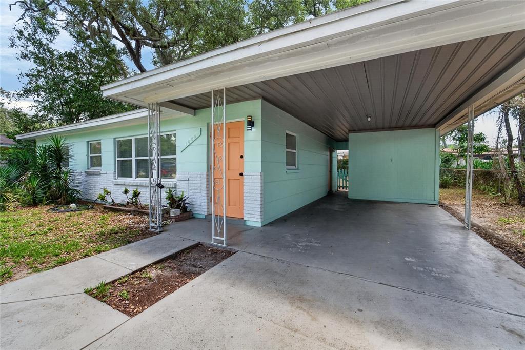 A light green single-story house with a flat roof and an attached carport — 3009 E FERN STREET, TAMPA, FL