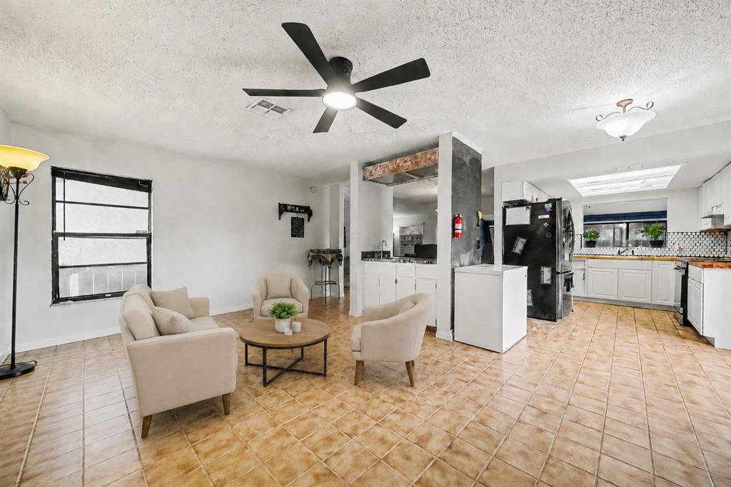A living room features a floating wooden console, two wall-mounted televisions, and a built-in shelf — 2008 HOUNDSLAKE DRIVE, WINTER PARK, FL