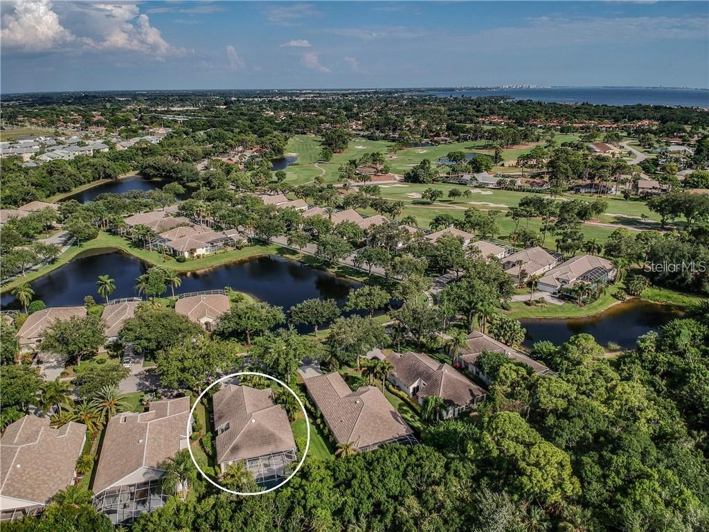 An aerial view shows a residential neighborhood with a circled house near a golf course — 4358 MIRABELLA CIRCLE, BRADENTON, FL