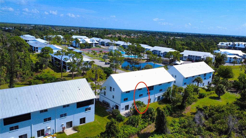 An aerial view of a multi-story apartment complex with a red oval highlighting a unit — 6800 PLACIDA ROAD UNIT TH-3D, ENGLEWOOD, FL