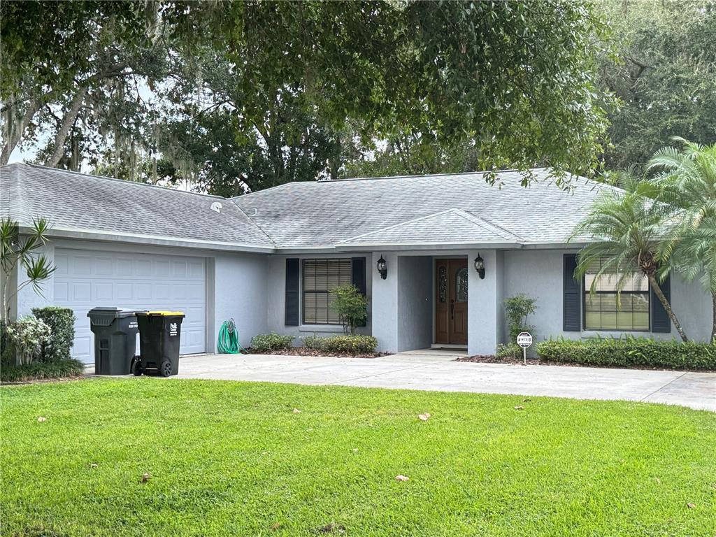 A kitchen features wood cabinets, a tiled countertop, a white refrigerator, and a ceiling fan — 10 FORT CLINCH HEIGHTS ROAD, FROSTPROOF, FL