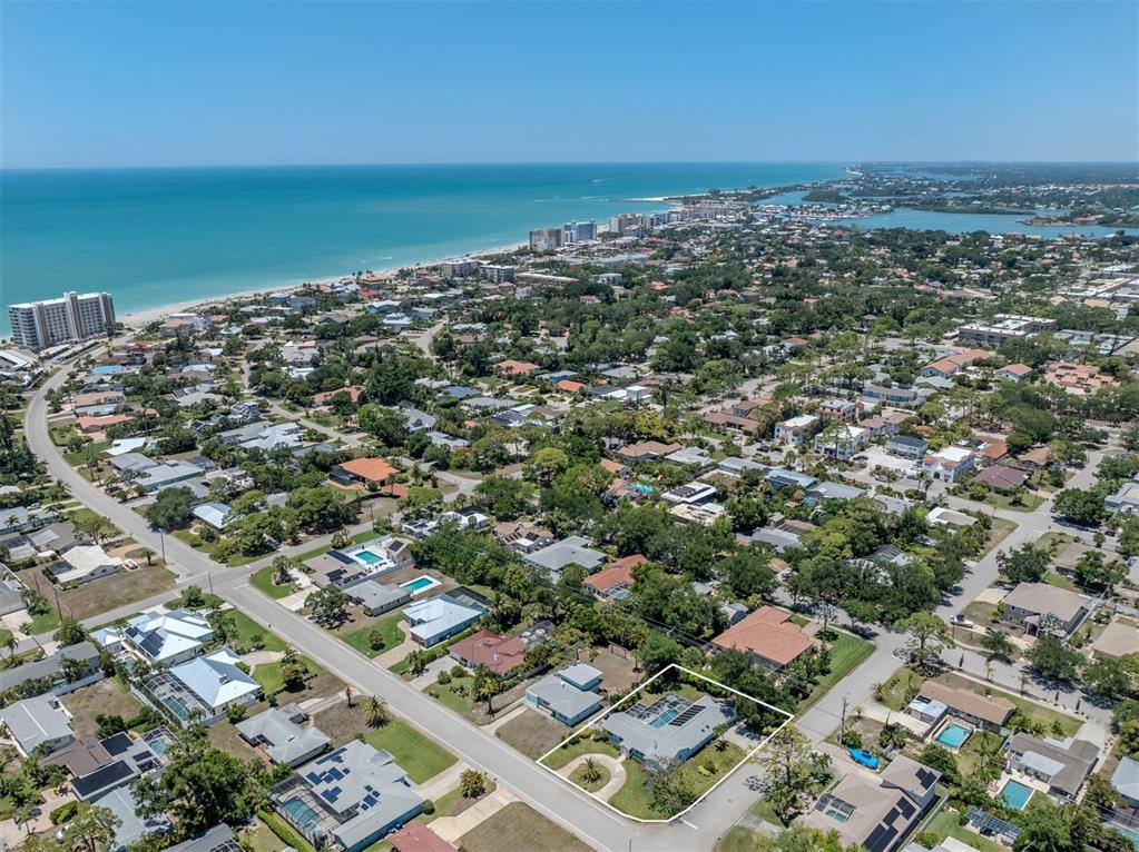 A light blue single-story house features a two-car garage, a concrete driveway, and palm trees — 500 ALHAMBRA ROAD, VENICE, FL