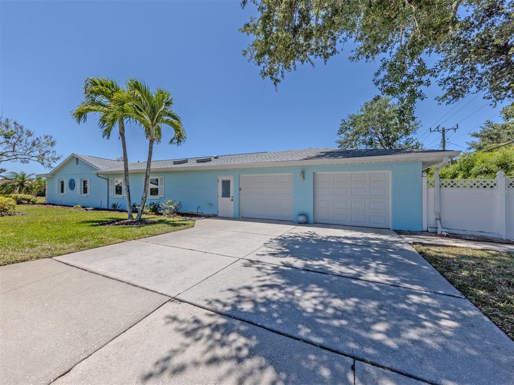 An aerial view shows a house with a shingled roof, solar panels, and a screened pool — 500 ALHAMBRA ROAD, VENICE, FL