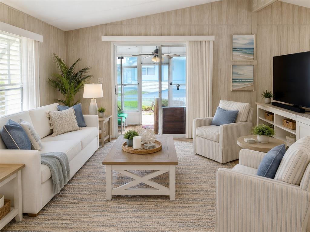 A living room features a white sofa, two striped armchairs, a coffee table, and wood-paneled walls — 915 MARK ROAD, LEESBURG, FL