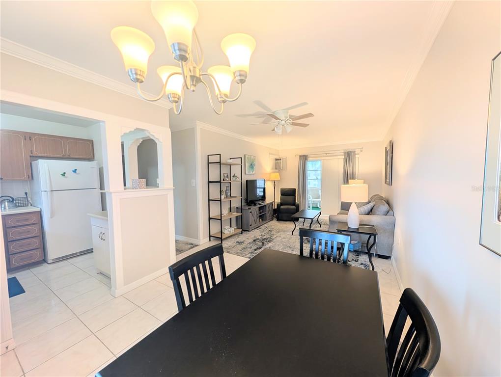 A dining area opens into a living room with a kitchen visible on the left — 1839 SUNNY DRIVE UNIT E36, BRADENTON, FL