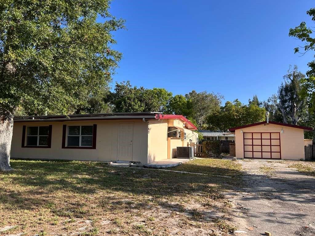 A single-story house with a detached garage and a paved driveway under a clear sky — 340 SANTA BARBARA STREET, NORTH FORT MYERS, FL