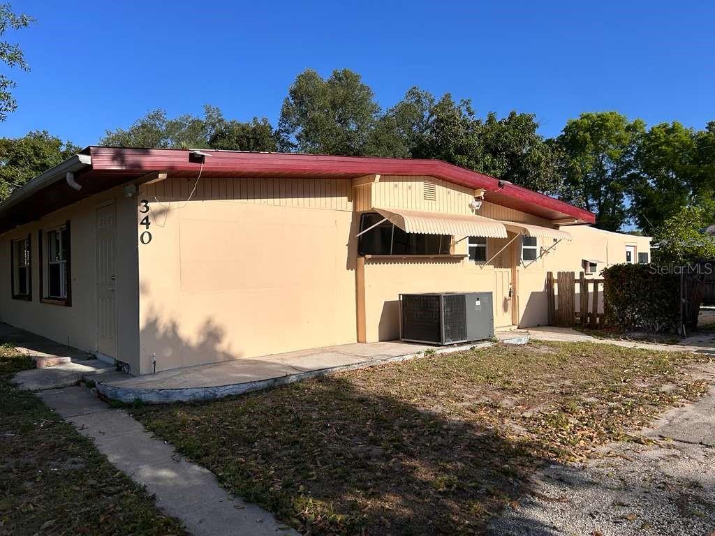 A single-story house with tan stucco walls, a red roofline, and an external air conditioning unit — 340 SANTA BARBARA STREET, NORTH FORT MYERS, FL