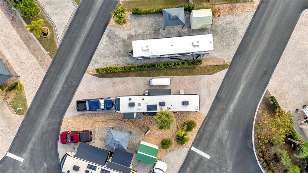An aerial view shows several RVs parked on paved lots with small structures and landscaping — 16404 BAY STREET, CLERMONT, FL