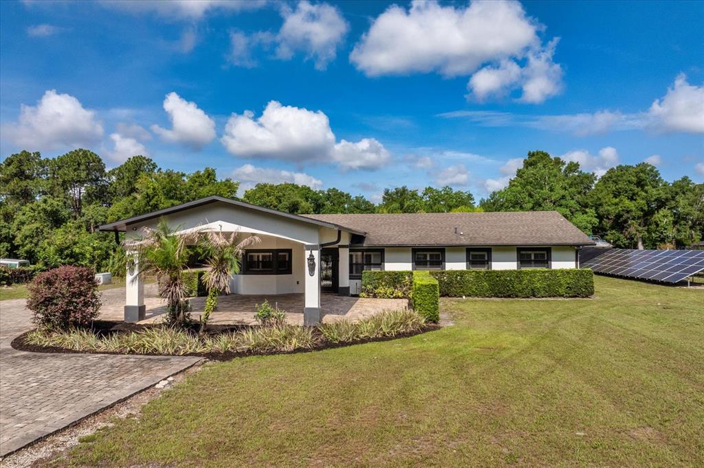 A screened-in patio features a swimming pool with a tanning ledge and an outdoor kitchen — 524 EDEN PARK, ALTAMONTE SPRINGS, FL