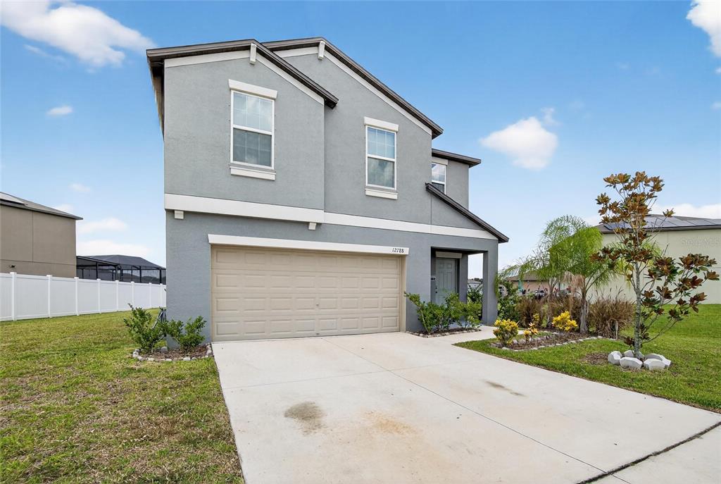 A two-story gray house with a two-car garage and a concrete driveway — 12788 MAPLE BONSAI DRIVE, RIVERVIEW, FL