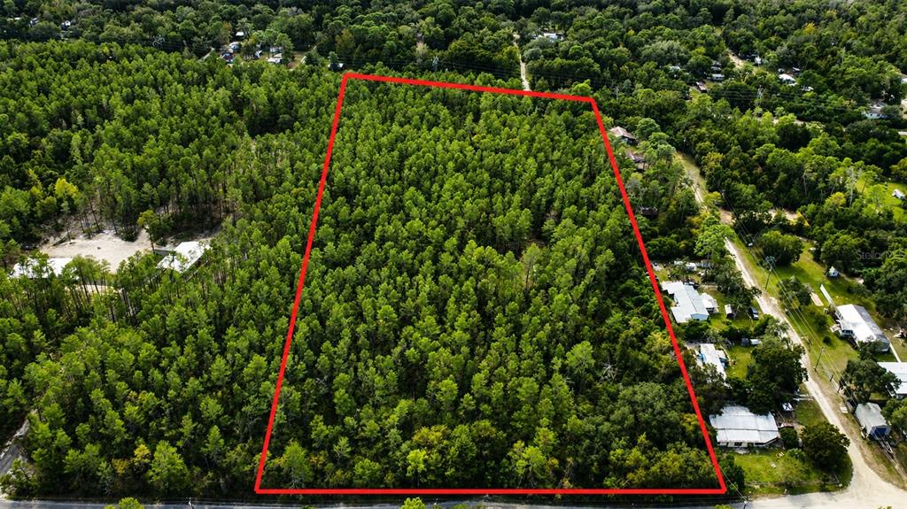 An aerial view shows a rectangular plot of wooded land outlined in red — 0 5TH STREET, ALTOONA, FL