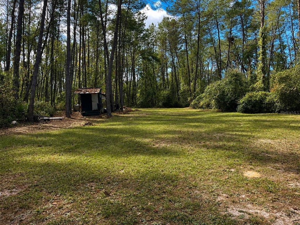 An aerial view shows a wooded lot with a silver trailer, a van, and a shed — 0 5TH STREET, ALTOONA, FL