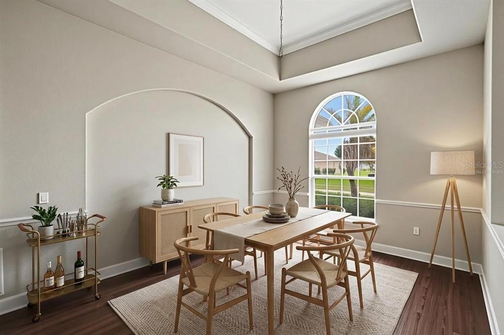 A dining room with a tray ceiling, arched wall niche, and a large arched window — 200 LAKE ARIETTA COURT, AUBURNDALE, FL