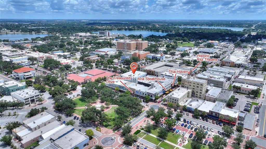 This aerial view shows a downtown city area with labeled businesses and a central park — 55 NW 3RD STREET NW, WINTER HAVEN, FL
