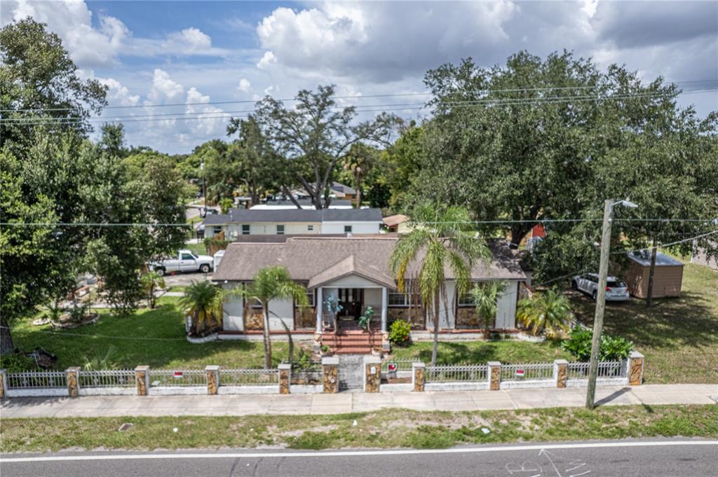 An aerial view of a single-story house with a fenced yard and palm trees — 5104 N 34TH STREET, TAMPA, FL