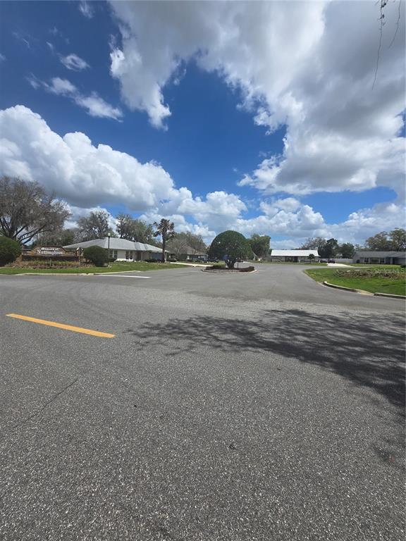 A street view shows a neighborhood entrance with a sign, a roundabout, and houses — 8140 WALT WILLIAMS ROAD, LAKELAND, FL