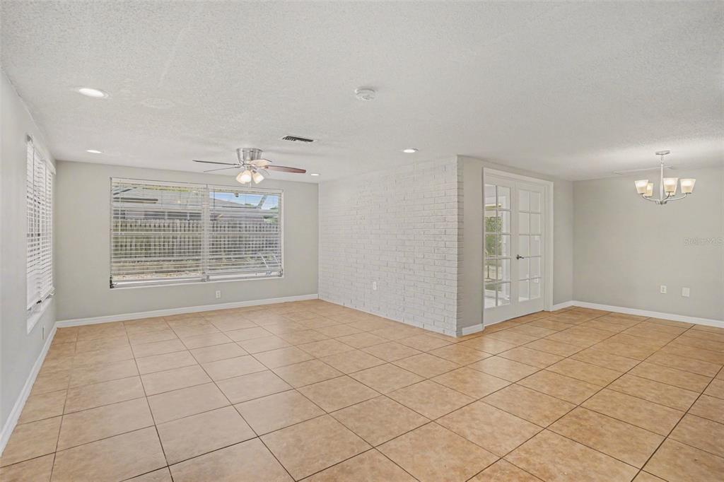 A kitchen with white cabinets, granite countertops, stainless steel appliances, and tiled flooring — 8006 MIMOSA DRIVE, PORT RICHEY, FL