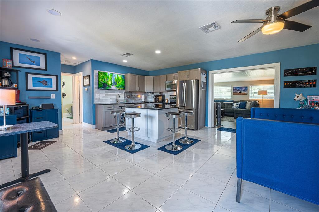 An aerial view shows a backyard patio with a shed, outdoor kitchen, and seating area — 5760 3RD AVENUE N, ST PETERSBURG, FL