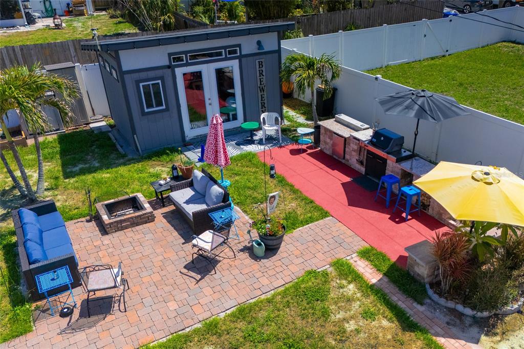 A small, gray-painted backyard shed with double glass doors and a "BREWERY" sign — 5760 3RD AVENUE N, ST PETERSBURG, FL