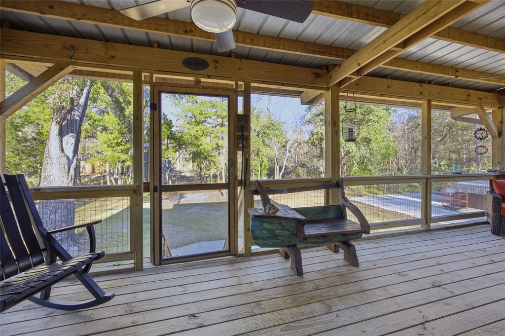 An elevated green house with solar panels on the roof and a concrete patio below — Track 79 CLAYTON ROAD, CEDAR KEY, FL