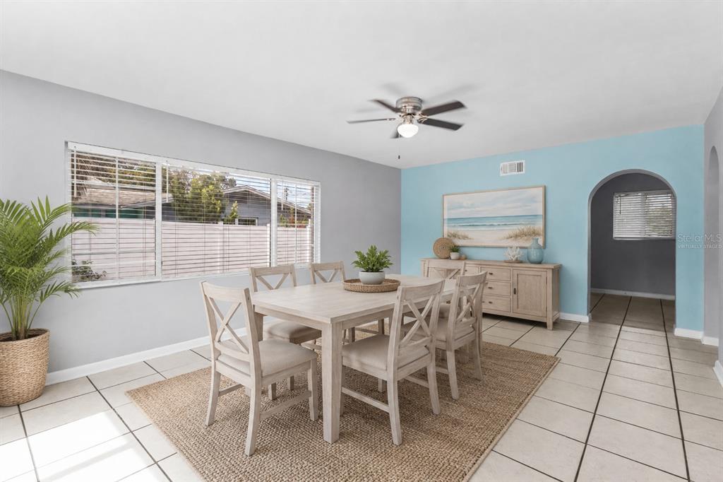 An empty room with light gray walls, white tile flooring, and two large windows — 605 S FLORIDA AVENUE, TARPON SPRINGS, FL