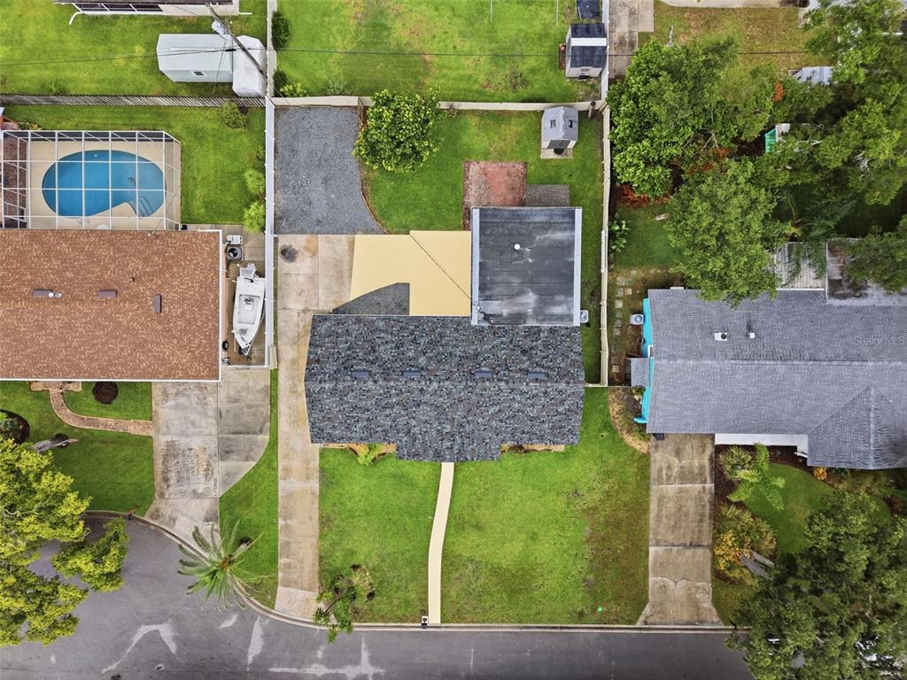 An aerial view shows a house with a shingled roof, a driveway, and a backyard — 59 CRESTWOOD CIRCLE, ORMOND BEACH, FL