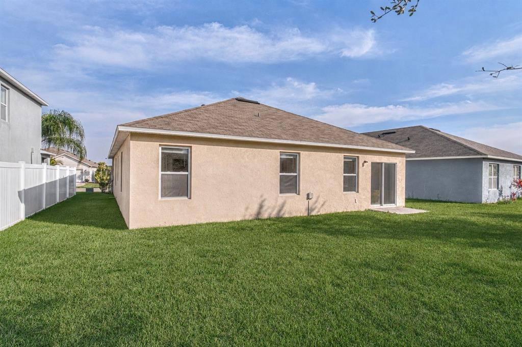An aerial view shows a house with a large backyard, a pool enclosure, and landscaping — 2952 GIBRALTAR BOULEVARD, NEW SMYRNA BEACH, FL