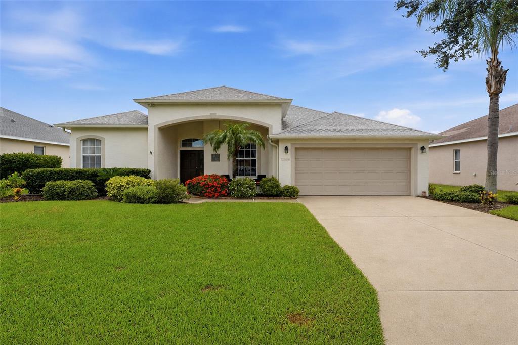 A dining room features a table, chandelier, tile floors, and an adjacent entryway — 12506 25TH COURT E, PARRISH, FL