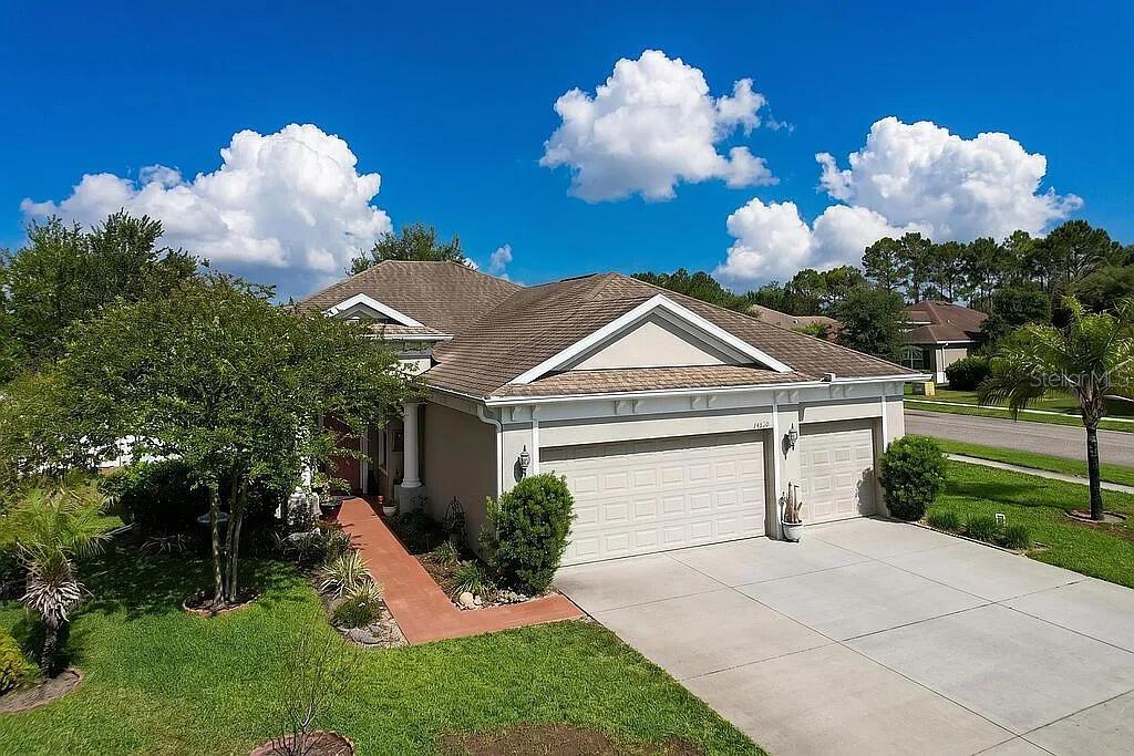 An aerial view of a single-story house with a two-car garage and landscaped yard — 14530 BALLOCH DRIVE, HUDSON, FL