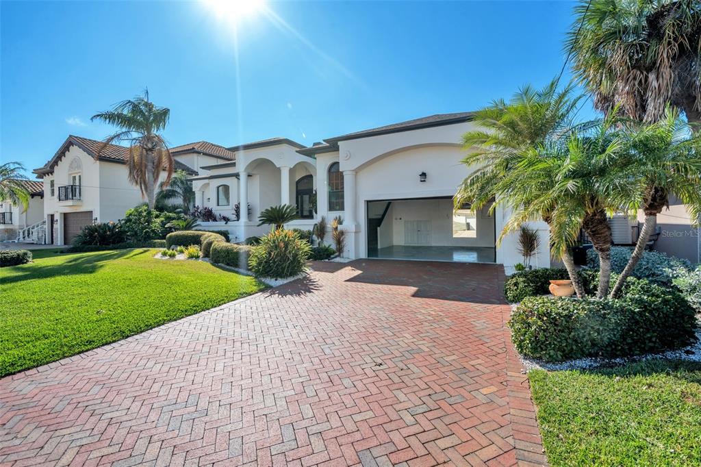 A living room features a marble fireplace, wood-look flooring, and sliding glass doors to a patio — 112 LEEWARD ISLAND, CLEARWATER, FL