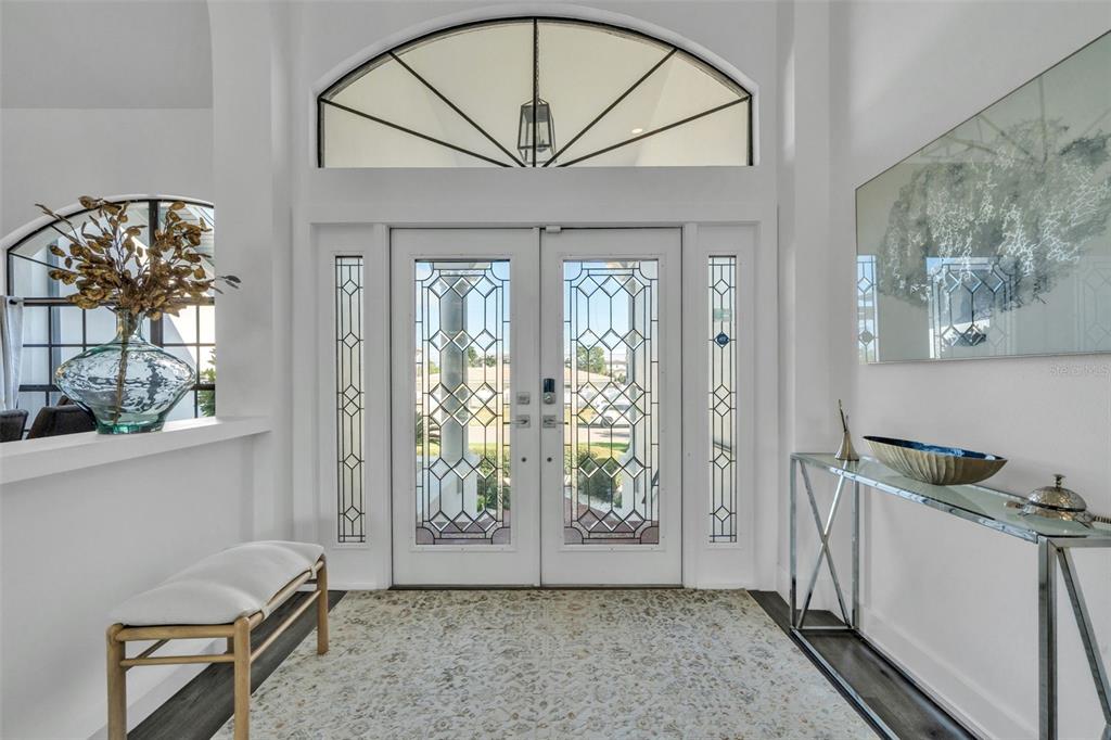 A living room features a marble fireplace, a large sectional sofa, and a ceiling fan — 112 LEEWARD ISLAND, CLEARWATER, FL