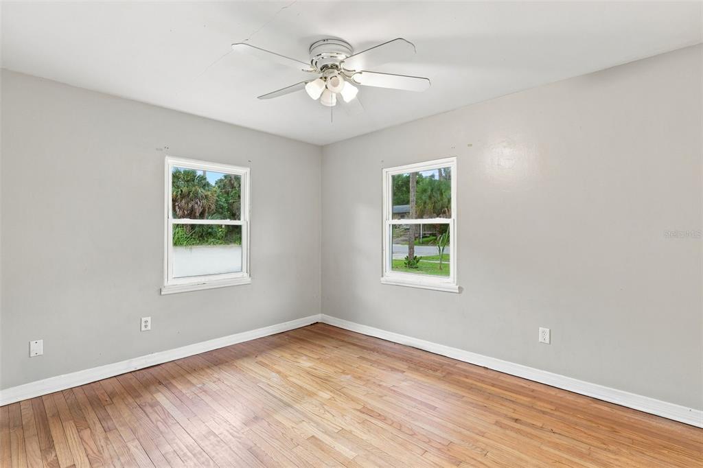 A view of a kitchen with wood cabinets and a dining area with hardwood floors — 320 W GRAVES AVENUE, ORANGE CITY, FL