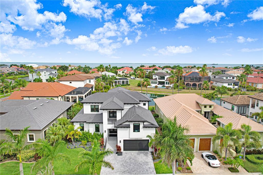 An aerial view of a modern two-story house with a gray roof and paved driveway — 6104 LAGOMAR LANE, APOLLO BEACH, FL