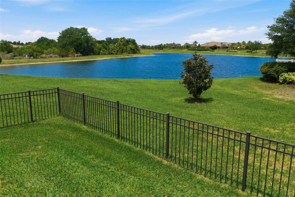 A single-story stucco house with a tile roof, two-car garage, and landscaped front yard — 5288 RUSHMERE COURT, PALMETTO, FL