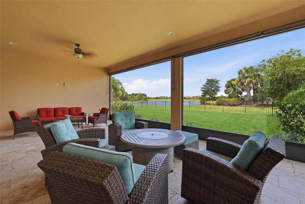 A single-story house with a tan stucco exterior, tile roof, and brick paver driveway — 5288 RUSHMERE COURT, PALMETTO, FL