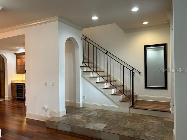 An entryway features a tiled floor, a wooden front door, and a staircase with railing — 1138 S PENNSYLVANIA AVENUE, WINTER PARK, FL