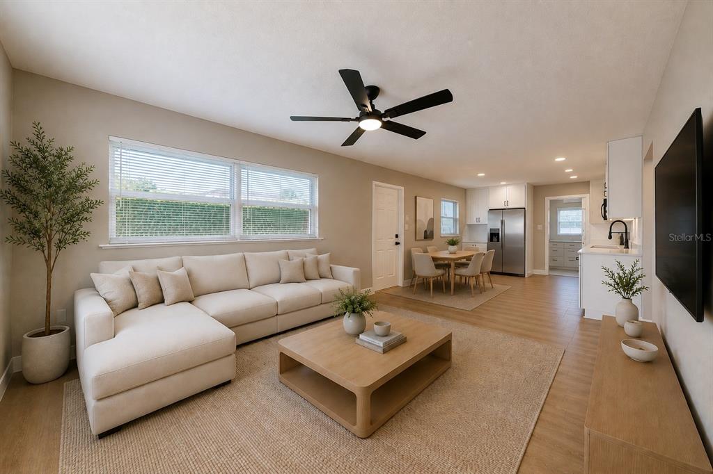 A living room with a sectional sofa, coffee table, and an adjacent dining area — 703 S DIXIE AVENUE, FRUITLAND PARK, FL