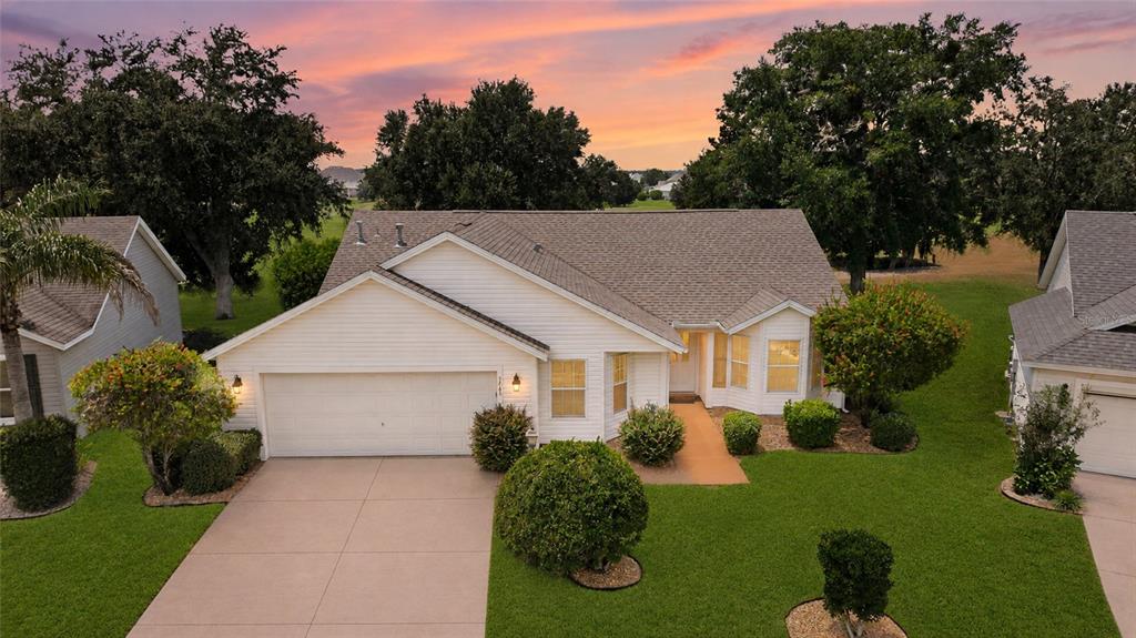 An aerial view of a single-story suburban house with a white exterior and attached garage — 1745 LAKEWOOD DRIVE, THE VILLAGES, FL