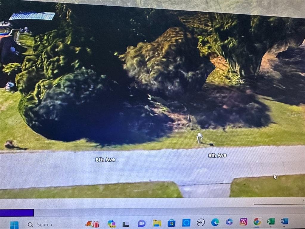 This is a satellite map view showing a grassy lot with trees along 8th Ave — 11335 EIGHTH AVENUE, PUNTA GORDA, FL