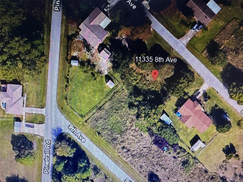 This is an aerial map view of a vacant residential lot and surrounding properties — 11335 EIGHTH AVENUE, PUNTA GORDA, FL
