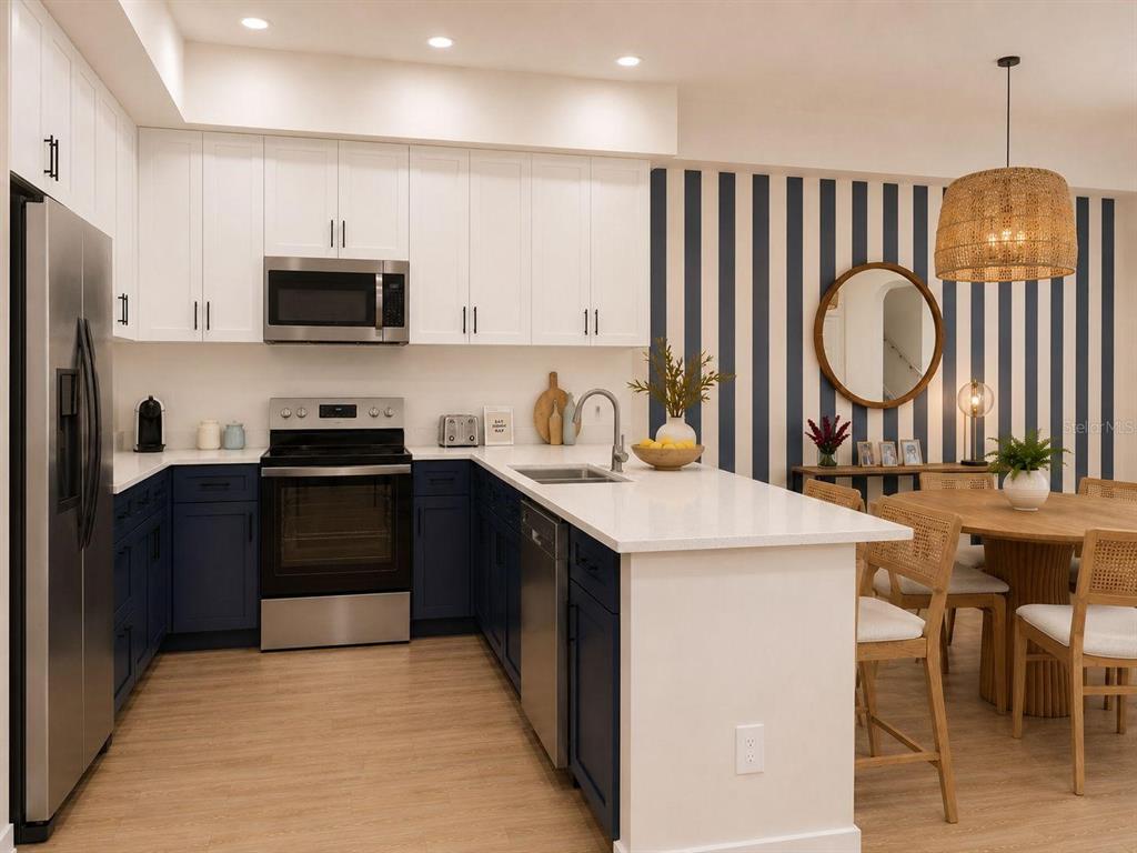 A modern kitchen features white upper cabinets, dark blue lower cabinets, and a striped accent wall — 139 TESSIE LANE, SANFORD, FL